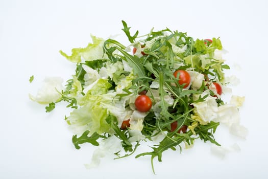 Heap of ruccola, lettuce leaves and cherry tomatoes