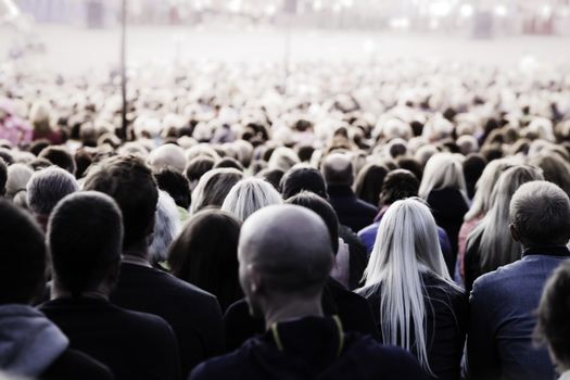 Crowd of unrecognisable people. Slow shutter speed motion blur for unrecognizability.