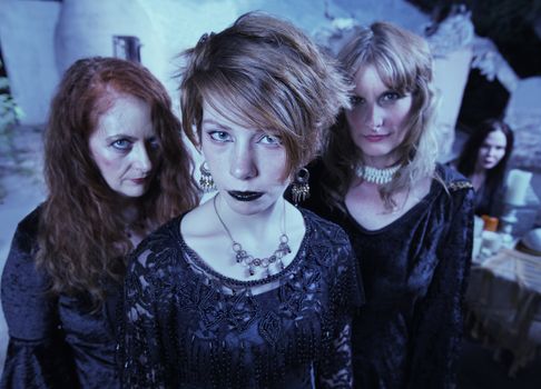 Trio of female adults in Wicca ceremony outdoors