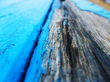 old blue painted wooden table surface decaying and chipping texture or wallpaper