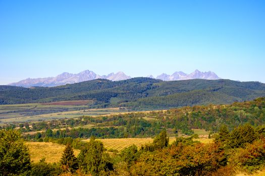 Landscape view of mountain range and autumn colorful hills and foliage, High Tatras, Slovakia