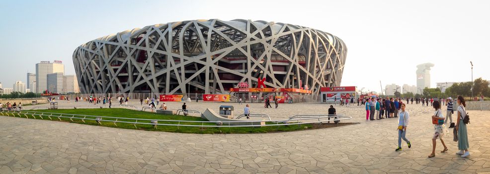 BEIJING, CHINA - SEPTEMBER 21, 2015: Tourists walking around the Bird Nets - China Natinal Olympic Stadium in Beijing, China, September 21, 2015