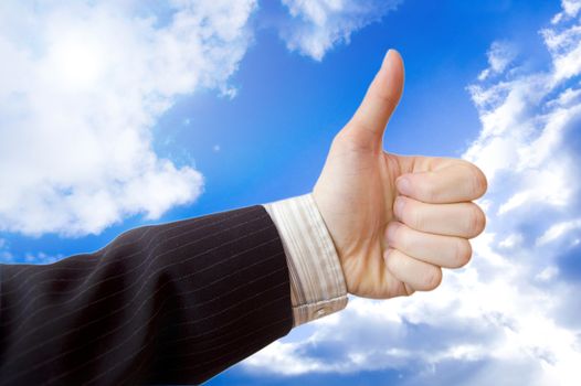 Success in business conceptual image. Businessman hand against the blue sky.