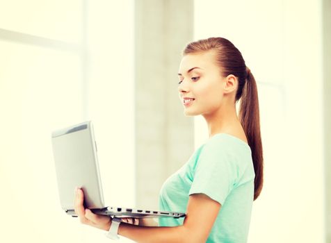 education and internet concept - smiling student girl with laptop at school