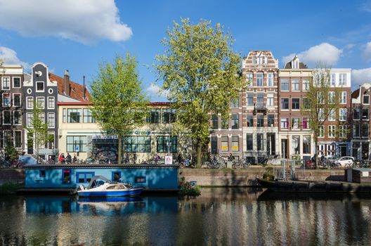 Amsterdam, Netherlands - May 7, 2015: People on the street in the city of Amsterdam on May 7, 2015. Amsterdam is the capital and most populous city of the Netherlands.