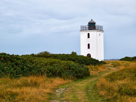 Small old traditional lighthouse on the coast Funen Denmark