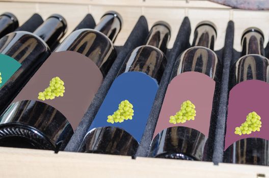 Red and white wine in bottles with grapes on the label in a wooden box.