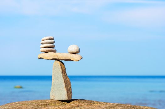 Balancing of white stones each other on the seashore