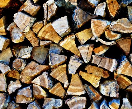 Stacked Rough Firewood Pinned Segments as Background closeup Outdoors