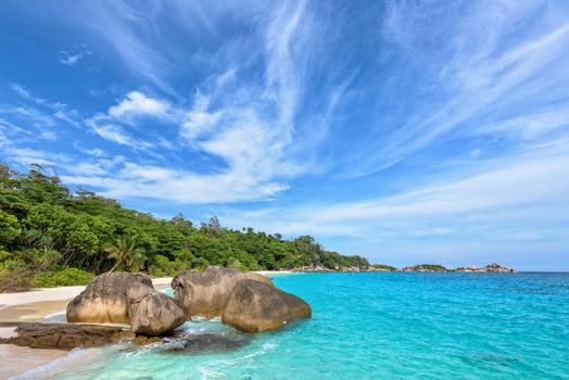 Beautiful landscape of blue sky sea sand and white waves on beach near the rocks during summer at Koh Miang island in Mu Ko Similan National Park, Phang Nga province, Thailand
