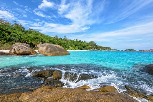 Beautiful landscape of blue sky sea and white waves on beach near the rocks during summer at Koh Miang island in Mu Ko Similan National Park, Phang Nga province, Thailand