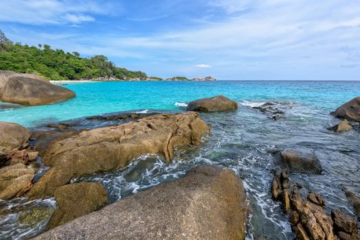 Beautiful landscape of blue sky sea and white waves on beach near the rocks during summer at Koh Miang island in Mu Ko Similan National Park, Phang Nga province, Thailand