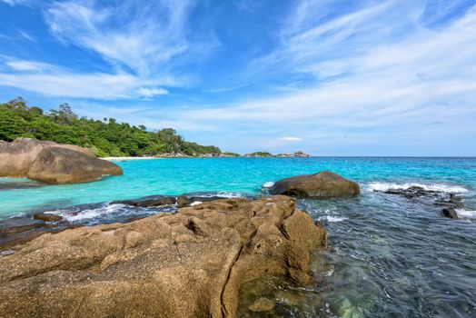 Beautiful landscape of blue sky sea and white waves on beach near the rocks during summer at Koh Miang island in Mu Ko Similan National Park, Phang Nga province, Thailand