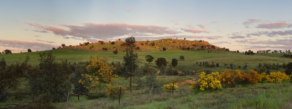 First rays of warm light highlight the hills at Wyangala in Central West NSW Australia