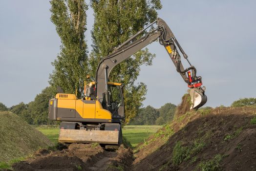 Agriculture shredded corn silage with an excavator in the Netherlands
