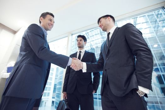 Business people shaking hands, finishing up a meeting in office