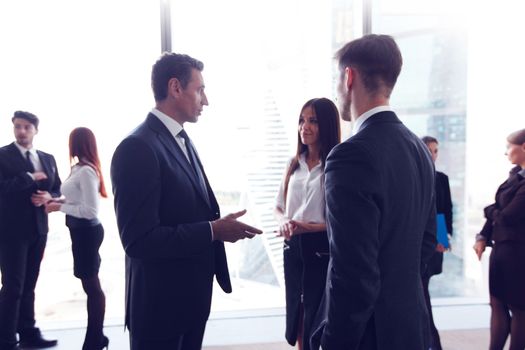 Business people talking in a conference room with city skyline