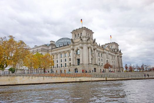 Reichstag in Berlin, Germany - view from river Spree, riverside