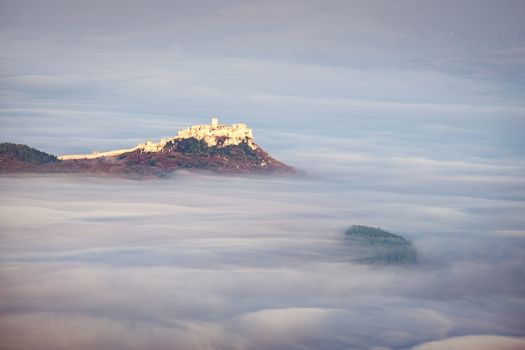 Scenic view of Spis castle at sunrise in dreamy style above clouds, Spisske Podhradie, Slovakia