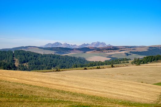 Landscape view of mountain range and autumn colorful hills, fields, meadows and foliage, High Tatras, Slovakia