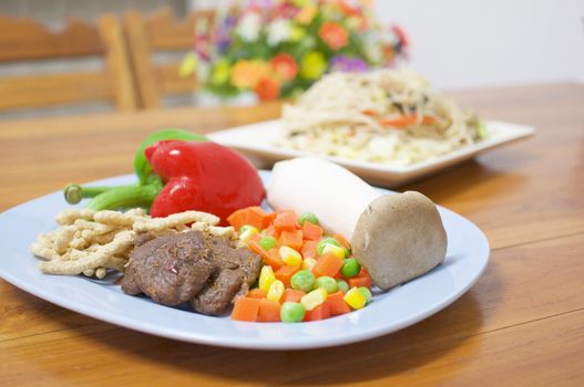 Carrots, mushroom, red and green bell pepper and vegan protein dry with blur long life noodle fried with cauliflower vegetarian food as background.