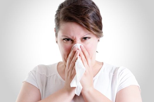 Middle age lady blowing her nose too hard, blowing your nose too hard can give you damage