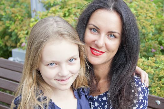 Portrait smiling mother and daughter in summer