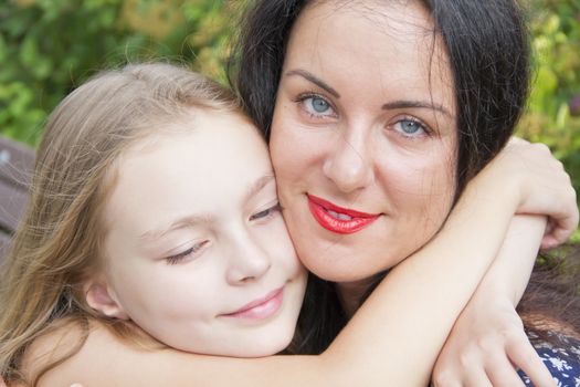 Portrait smiling mother and daughter in summer