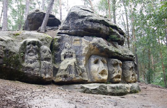 Harpist - rock sculptures of giant heads and other sculptures carved into the sandstone cliffs in the pine forest above the village Zelizy in the district Melnik, Czech republic. It is the works of sculptor Vaclav Levy, who created in the period 1841-1846.