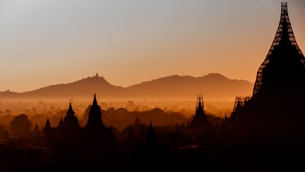 The sun is rising over the temples of Bagan