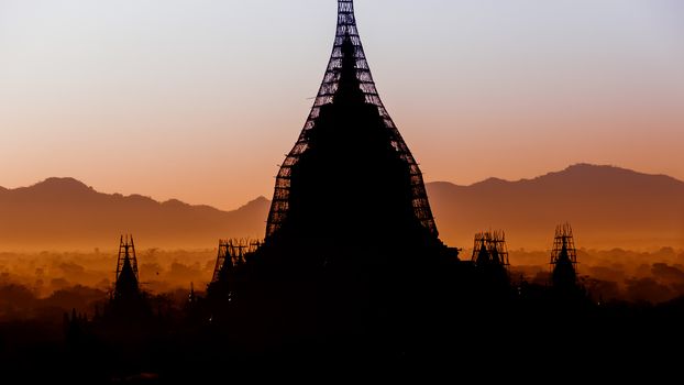 The sun is rising over the temples of Bagan