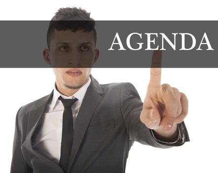 Young businessman with text agenda isolated on white background