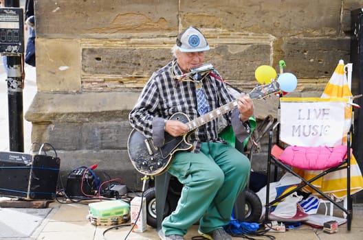 Street band play in York UK, music promotion, tourist attraction, the way to make money, editorial photo.