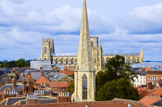 Looking out at the view from the top of Cliffords Tower in York. Include York Minster, St Wilfrids Catholic Church
