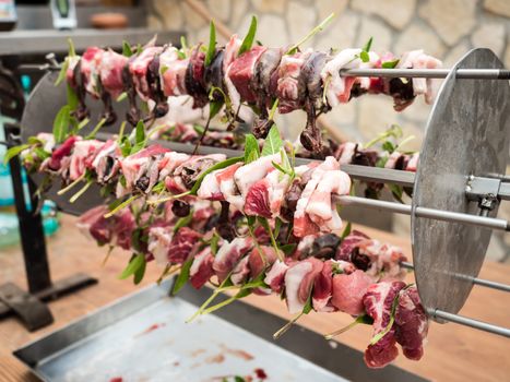 birds on the spit with meat, bacon and sage ready for roasting