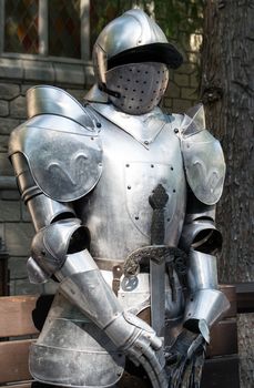 Medieval armor in front of the entrance to a castle.