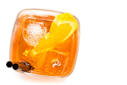 top of view of glass of spritz aperitif aperol cocktail with orange slices and ice cubes on white background with space for text