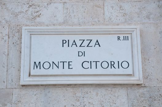 Road sign indicating a street name in Italian "piazza di Montecitorio" in English means Montecitorio square, rome