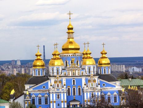 Saint Michael Monastery Cathedral Steeples Spires Tower Golden Dome Facade Kiev Ukraine.  Saint Michael's is a functioning Greek Orthordox Monasatery in Kiev.  The original monastery was created in the 1100s but was destroyed by the Soviet Union in the 1930s.  St. Michaels was reconstructed after Ukrainian independencein 1991 and reopened in 1999.