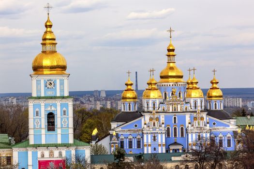 Saint Michael Monastery Cathedral Steeples Spires Tower Golden Dome Facade Kiev Ukraine.  Saint Michael's is a functioning Greek Orthordox Monasatery in Kiev.  The original monastery was created in the 1100s but was destroyed by the Soviet Union in the 1930s.  St. Michaels was reconstructed after Ukrainian independencein 1991 and reopened in 1999.