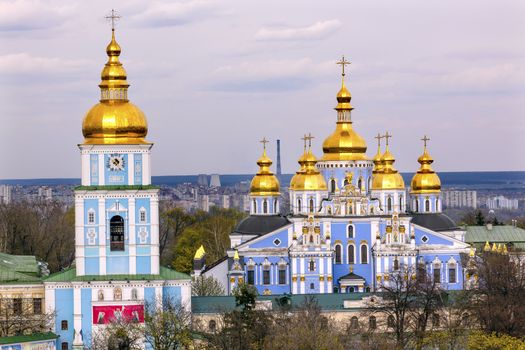 Saint Michael Monastery Cathedral Steeples Spires Tower Golden Dome Facade Kiev Ukraine.  Saint Michael's is a functioning Greek Orthordox Monasatery in Kiev.  The original monastery was created in the 1100s but was destroyed by the Soviet Union in the 1930s.  St. Michaels was reconstructed after Ukrainian independencein 1991 and reopened in 1999.