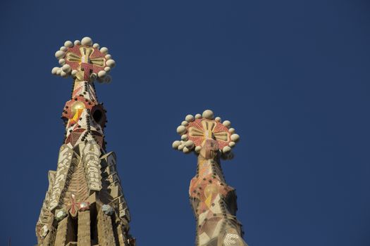 Barcelona, Spain - September 21, 2015: Two of the temple of  the Sagrada Famila towers ornaments.  Gaudi's profound catholicism inspired his designs of Sagrada Familia.