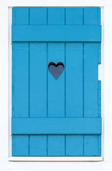 Blue wooden shutter with a carved heart 