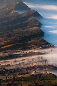 Village next to volcano Bromo, covered in fog