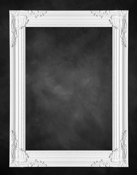 white classical vintage frame on black chalkboard