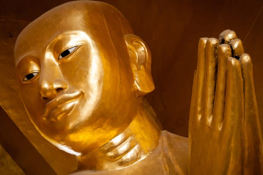 Close-up of a praying golden buddha face in temple in Bagan myanmar