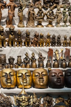 Mask sculpture made of copper and bronze at a market in Bagan Myanmar Burma