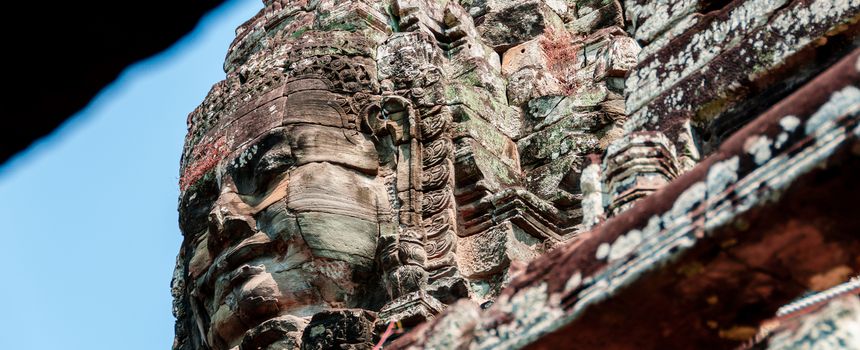 Head encarved in stone Bayon temple Angkor Wat Cambodia