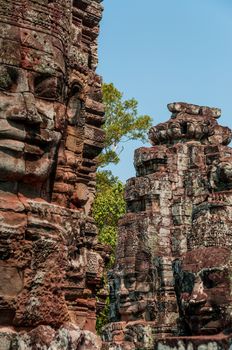 Head encarved in stone Bayon temple Angkor Wat Cambodia