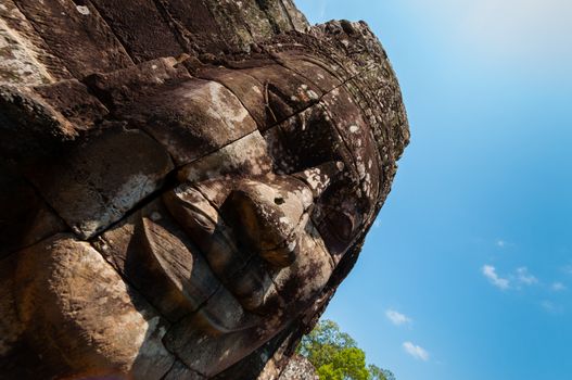 Head encarved in stone Bayon temple Angkor Wat Cambodia